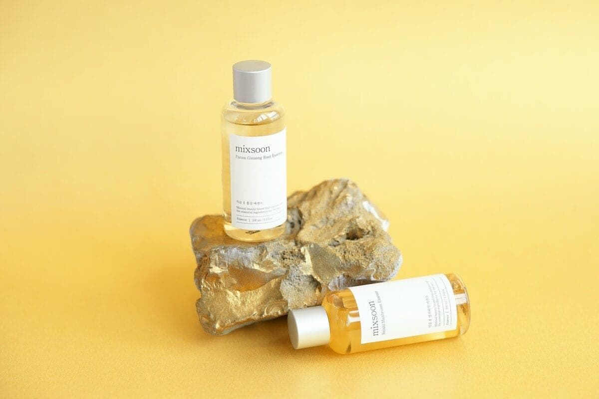 Bottles of skincare products on a rock.
