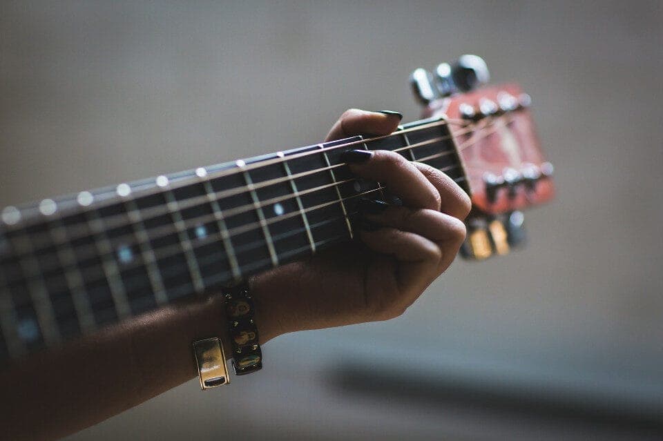 Girl Playing Guitar – Fretboard Close Up