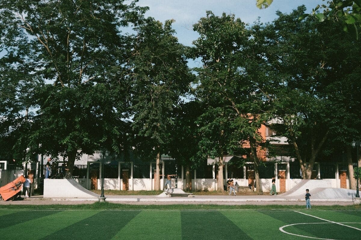 A soccer field in front of a large building