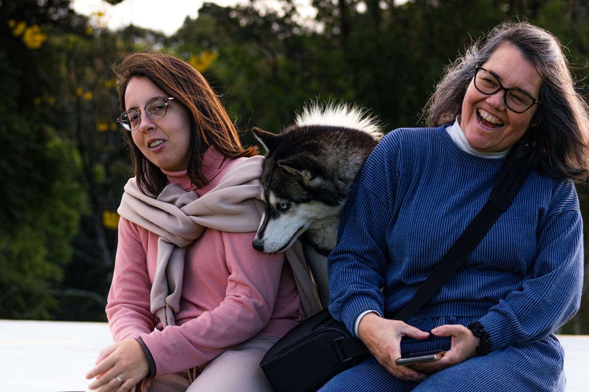 Two women and a husky dog outdoor