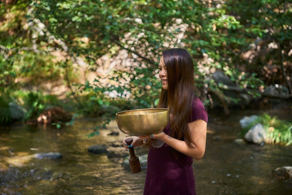 A woman in a purple dress is holding a bowl