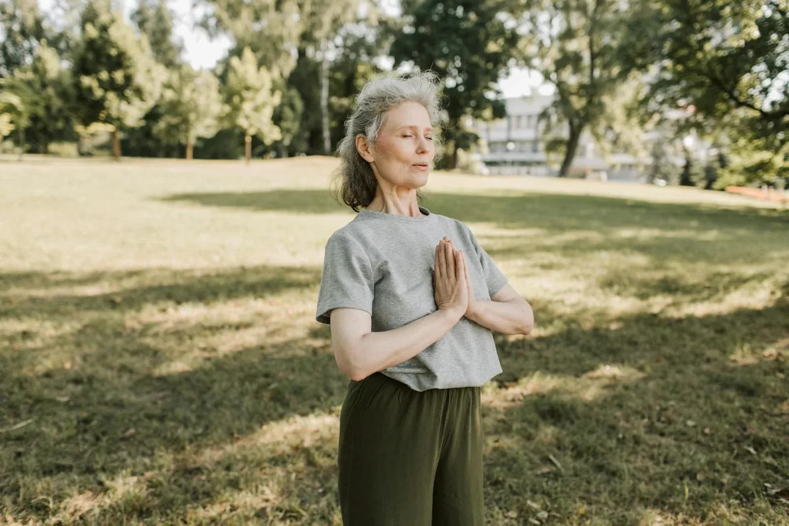 Woman meditating in a park — menopause brain health
