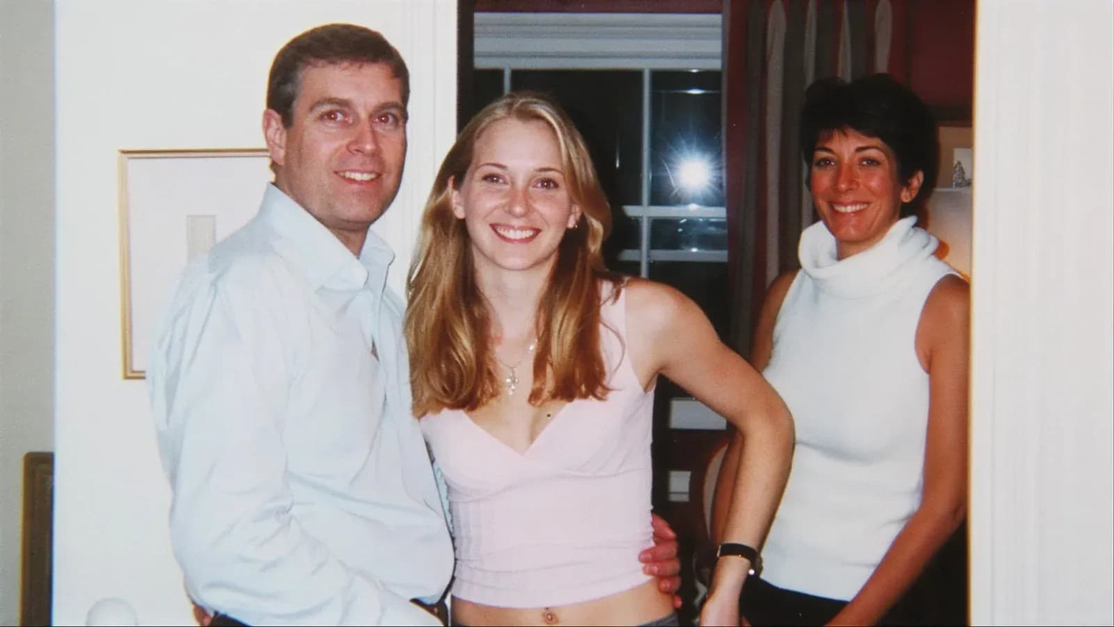 Prince Andrew with his arm around Virginia Giuffre, then 17, alongside Ghislaine Maxwell at Maxwell's London townhouse in 2001