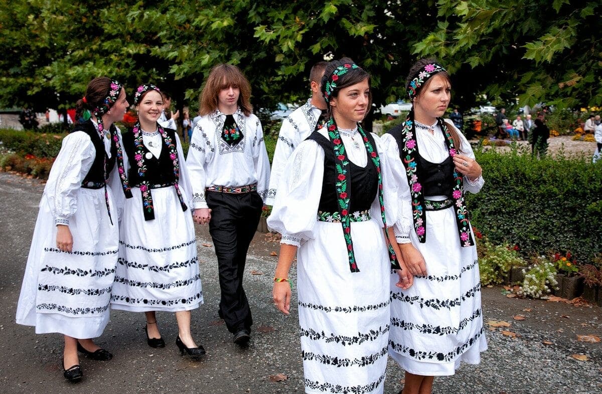 A group of women walking down a street