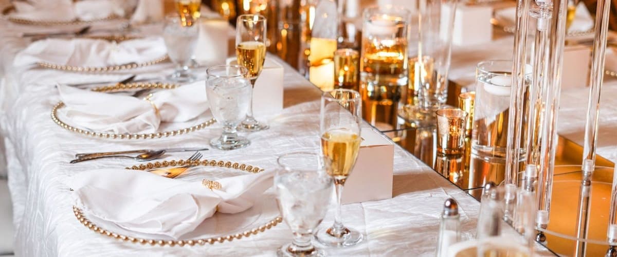 Elegant table setting with champagne glasses and white linens